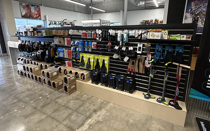Bike components lined up on a dirt trail, ready for installation
